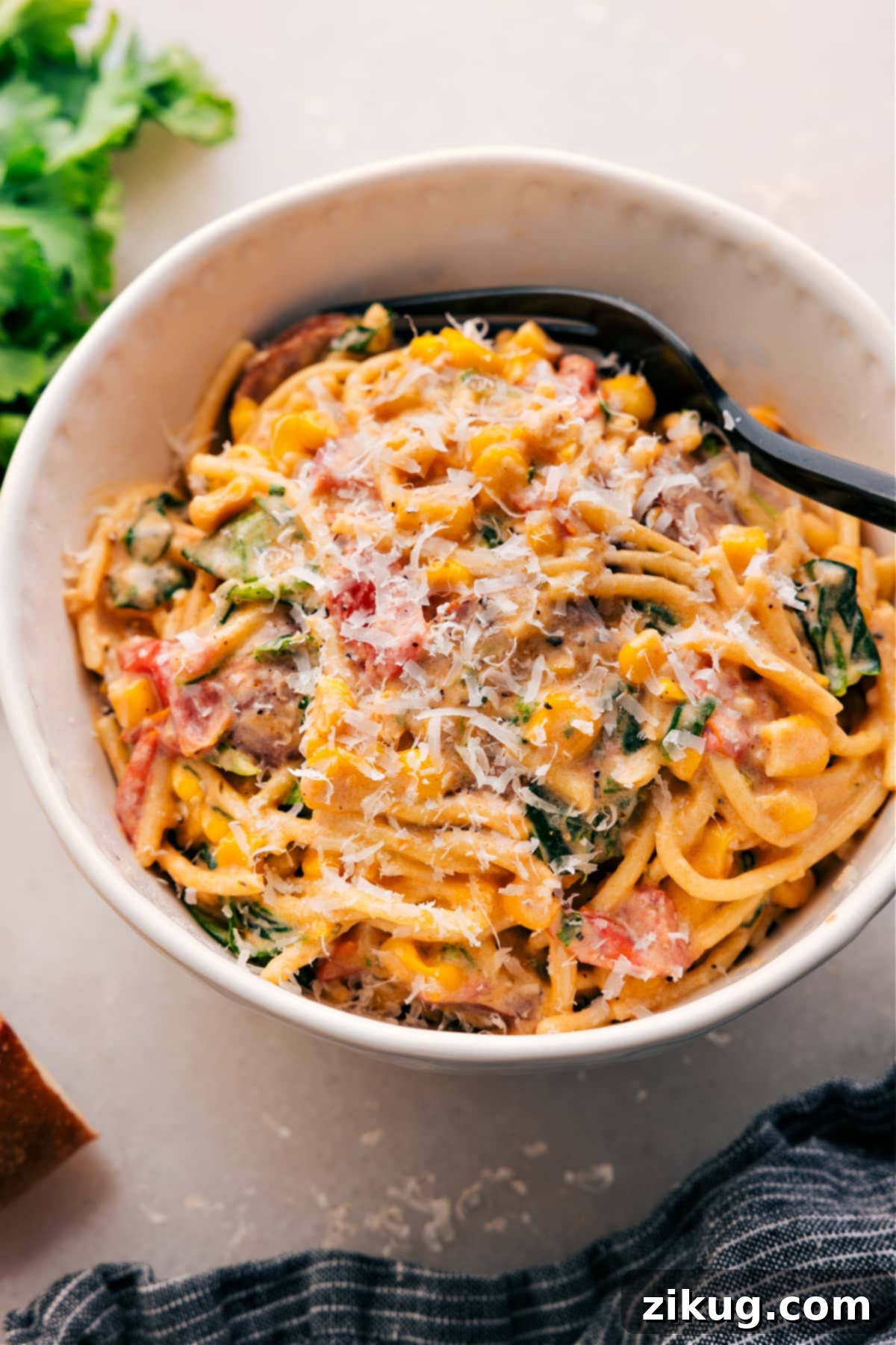 Creamy Sausage and Sweet Corn Pasta 2 Hearty Corn and Sausage Pasta topped with fresh parmesan in a white bowl, ready to be enjoyed.