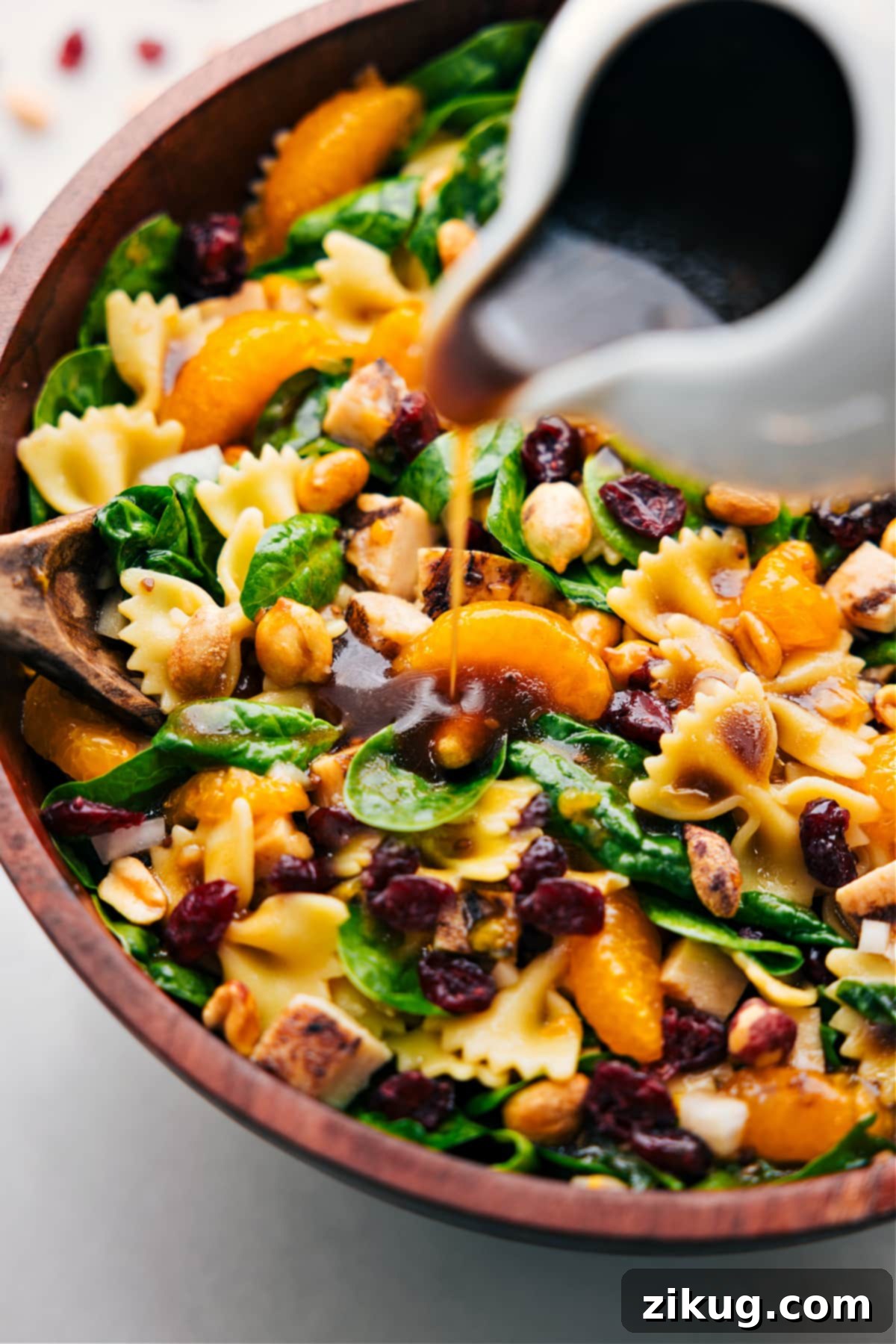 How To Make The Best Teriyaki Chicken Salad Recipe Teriyaki Chicken Salad dressing being poured over the prepared dish, ready to be tossed together and served for a vibrant and appealing meal.