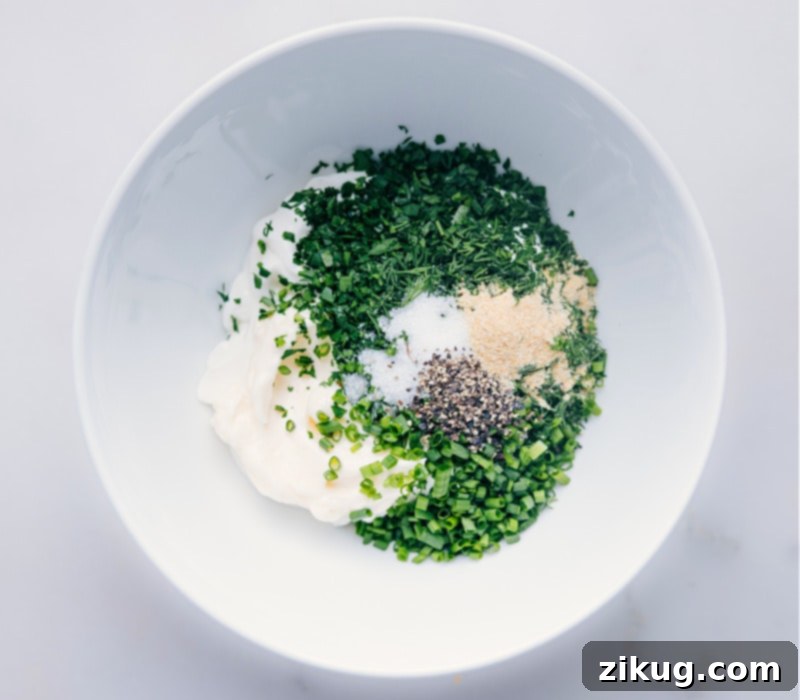 Your New Favorite Homemade Ranch 3 Image showing all the fresh ingredients for Ranch Dressing in a mixing bowl.
