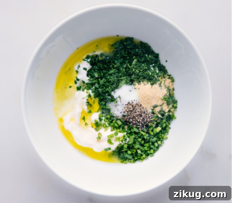 Your New Favorite Homemade Ranch 4 Process shot: Olive oil being drizzled into a bowl containing other Ranch Dressing ingredients.