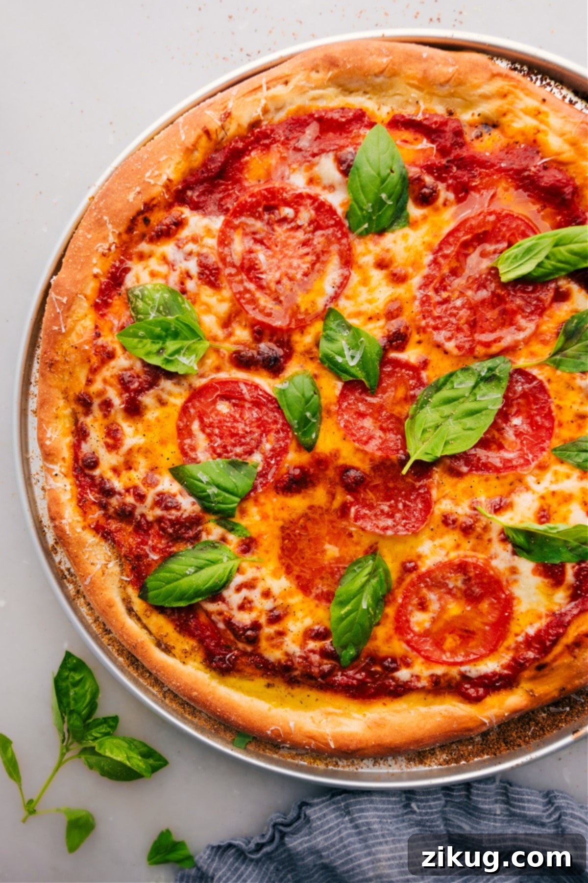 The Best Homemade Pizza Dough Recipe for Crispy and Chewy Crust Delicious homemade pizza with golden-brown crust, melted cheese, and fresh basil, ready to be sliced and enjoyed.