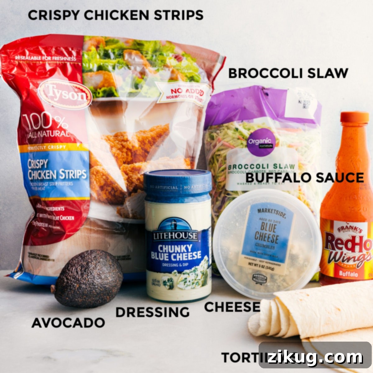 Kickin Buffalo Chicken Wraps 2 All the ingredients in this recipe, including crispy chicken strips, blue cheese dressing, sauce, broccoli slaw, tortillas, cheese, and avocado, are prepped and ready for easy assembly.