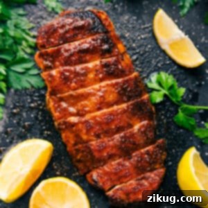 A beautifully presented serving of baked chicken breast, ready to be enjoyed.