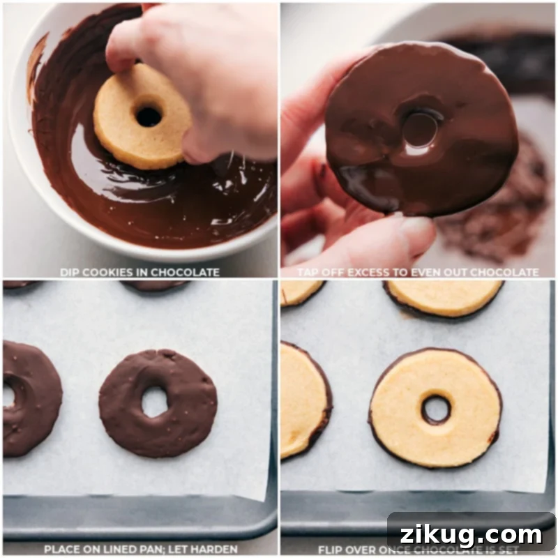 These delicious Homemade Fudge-Striped Cookies deliver a buttery, sweet cookie coated in smooth melted chocolate. With a hint of vanilla and just the right amount of salt, they're a sweet, satisfying cookie -- near impossible to stop at just one! This image shows the step of dipping the cookie bases in chocolate. #dessert #best #quick #easy #simple #treat #chocolate #sliceandbake #fudgestriped #cookies Process shots showing the baked cookies being carefully dipped into a bowl of melted chocolate to create the iconic fudge base.