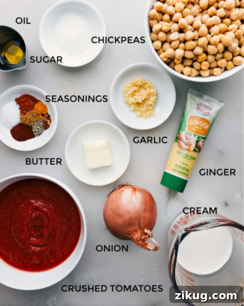 Fresh ingredients ready for your Butter Chickpeas recipe. A flat lay photograph showcasing all the fresh and pantry ingredients laid out neatly for making Butter Chickpeas.