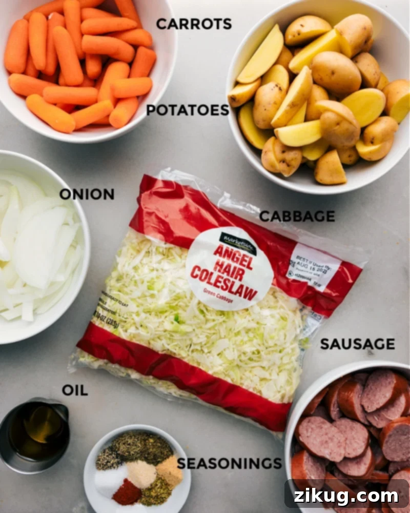 Essential ingredients for the hearty Cabbage, Potatoes, and Sausage sheet pan dinner, ready for preparation. Layout of all fresh ingredients for One-Pan Cabbage, Potatoes, and Sausage on a rustic wooden board, including baby gold potatoes, petite baby carrots, shredded green cabbage, yellow onion, sliced smoked sausage, a bottle of olive oil, and small bowls of various dried seasonings.