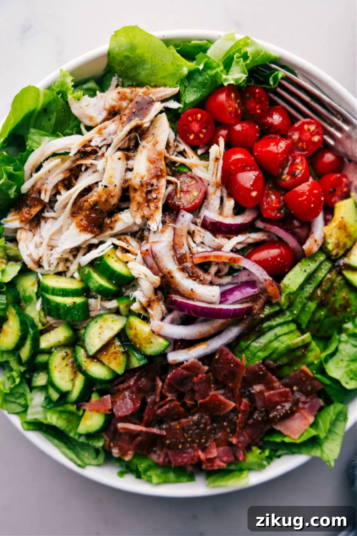 The Best Turkey Bacon Avocado Salad A large, beautifully composed bowl of Turkey Bacon Avocado Salad, perfectly tossed with all ingredients and dressing, invitingly presented and ready to be served, capturing its vibrant colors and rich textures.
