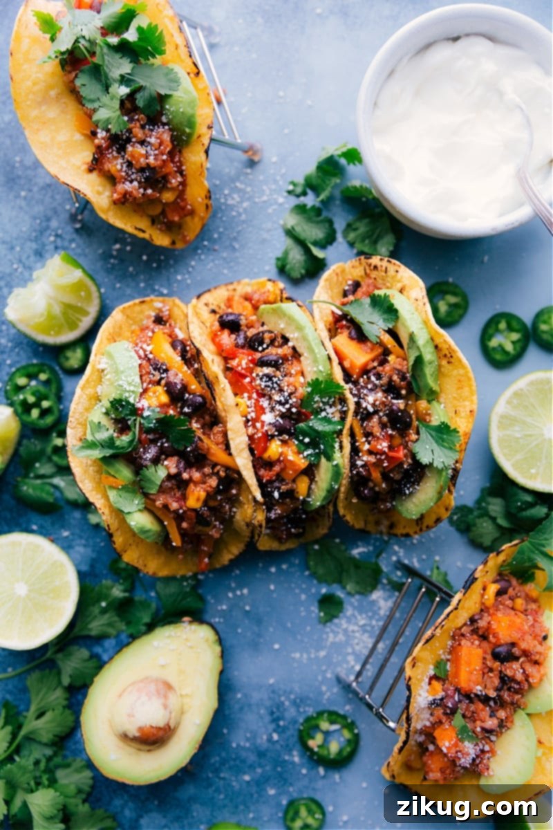 Delicious Quinoa Fajitas in warm tortillas, topped with fresh ingredients, perfect for a healthy and easy dinner. Overhead image of Quinoa Fajitas in tortillas, ready to be served, garnished with fresh cilantro and lime.
