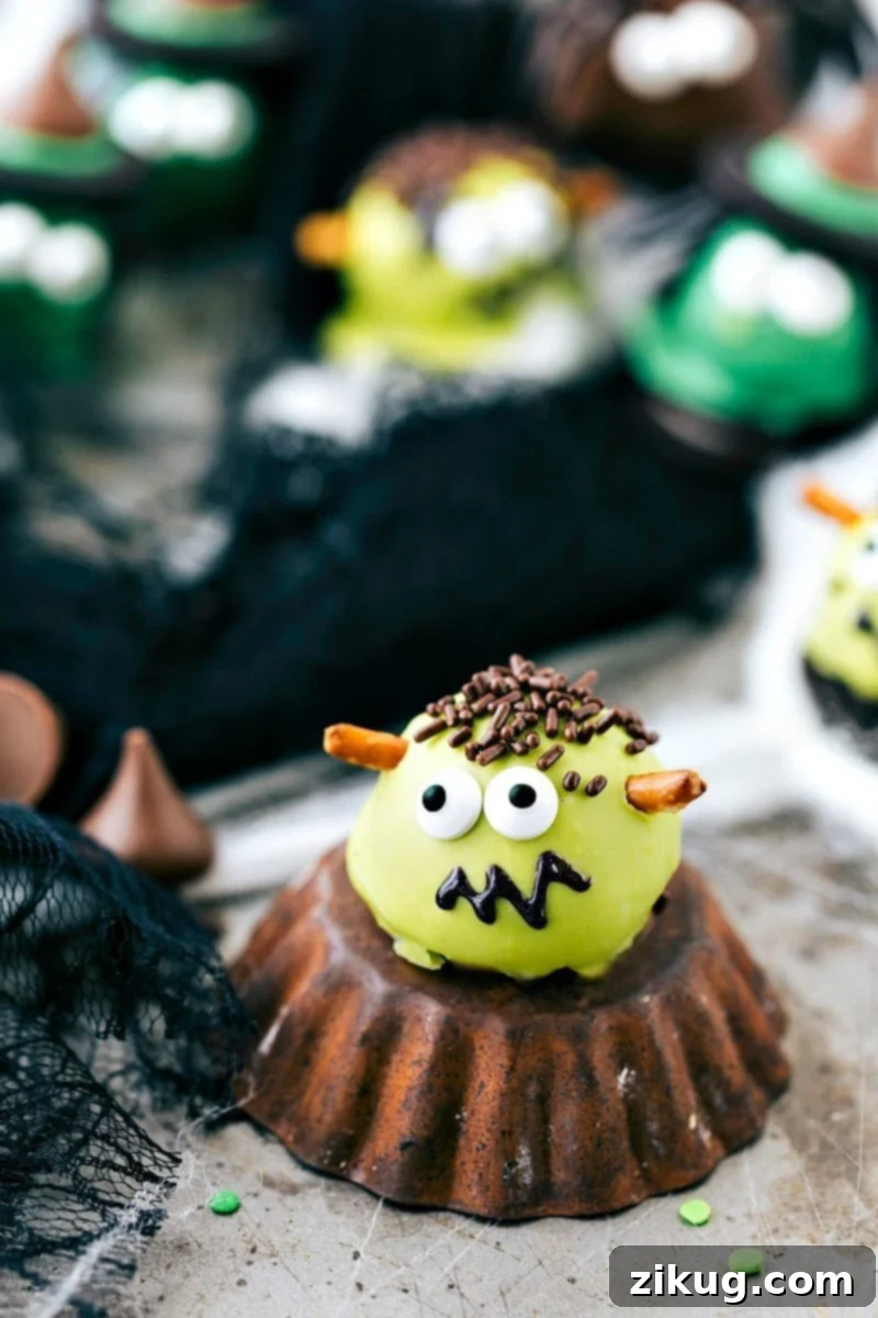 Spooktacular Oreo Truffles 9 A green Frankenstein Oreo ball with pretzel bolts, edible eyes, and a drawn black sparkle gel mouth, a cute and easy Halloween treat.