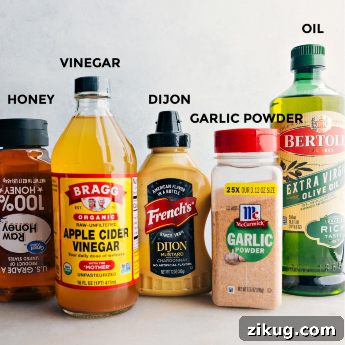 How To Make Chick-Fil-A Kale Salad Dressing All the individual ingredients required for the Chick-Fil-A Kale Salad dressing are meticulously laid out, showcasing the components like olive oil, honey, Dijon mustard, and apple cider vinegar, all ready to be combined for a delicious mix.