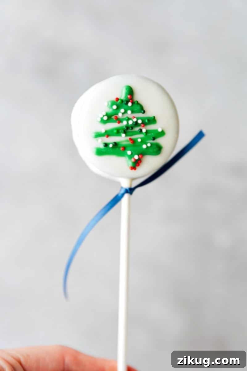 Cheerful Christmas tree Oreo pops, perfect for festive gatherings. Image of the Christmas Tree Oreo Pop decorated with colorful sprinkles.