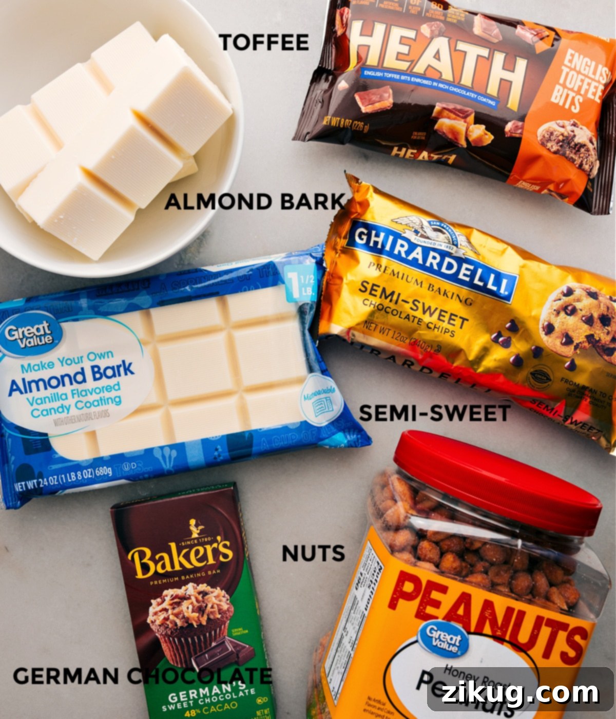 Key ingredients for Crockpot Candy laid out: vanilla almond bark, semi-sweet chocolate chips, German chocolate bar, and honey-roasted peanuts.