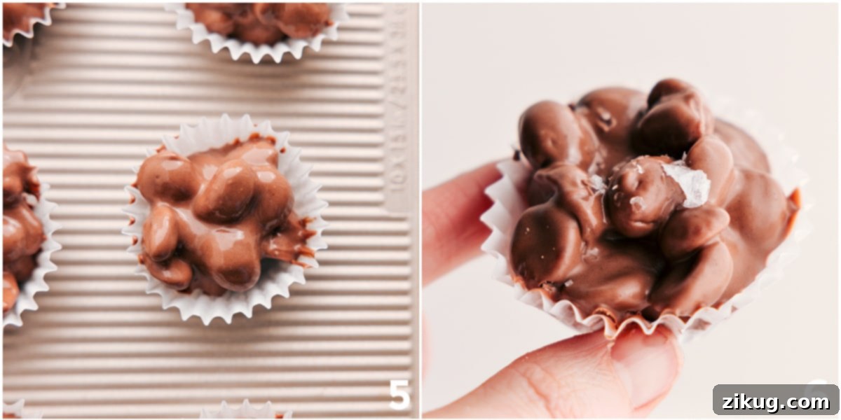 Freshly scooped slow cooker chocolate peanut clusters in mini muffin cups, adorned with a sprinkle of flaky sea salt.