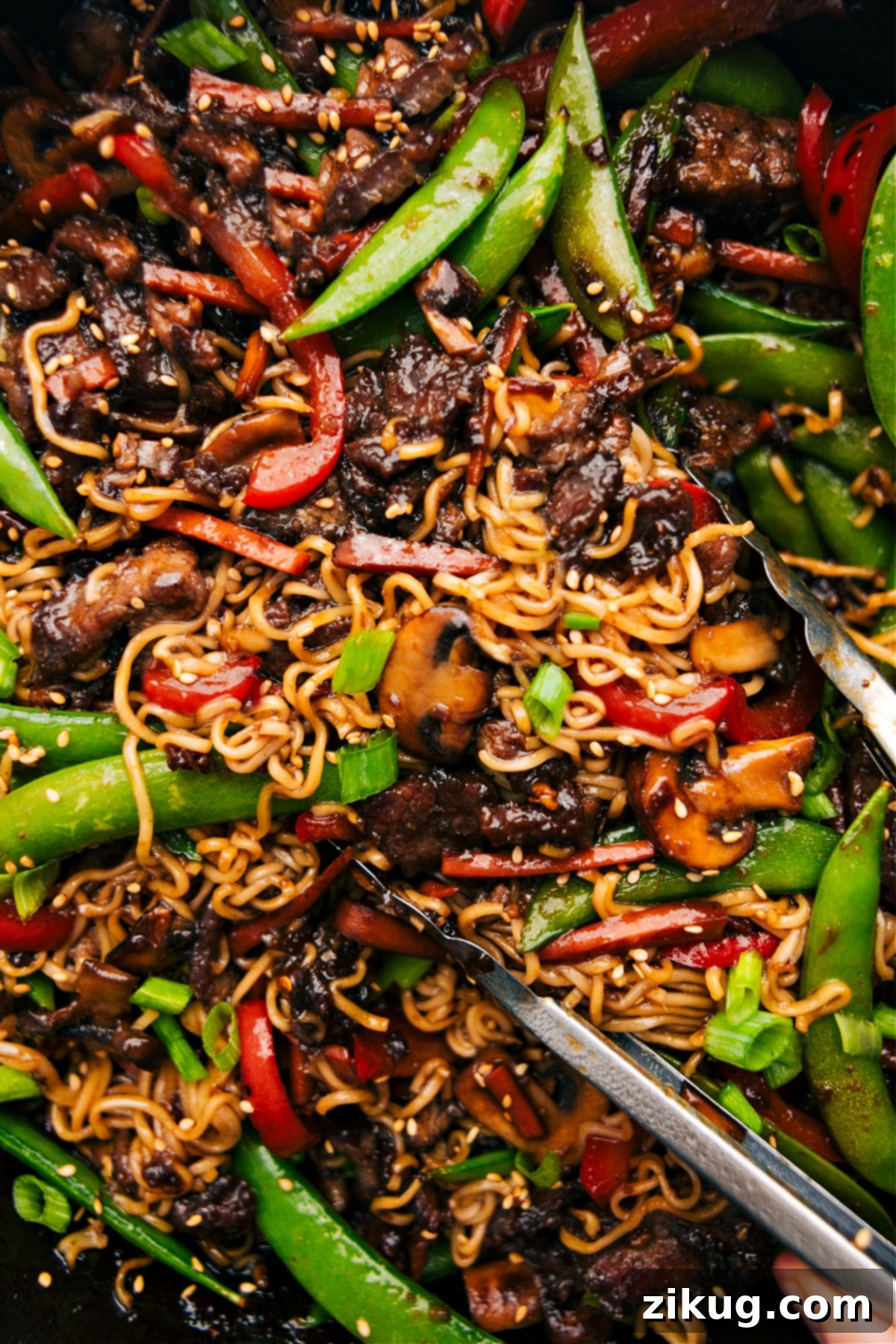 Your New Favorite: The Ultimate Garlic Beef And Veggie Ramen Recipe A generously portioned bowl of Garlic Beef and Veggie Ramen, showcasing the rich sauce, tender beef, colorful vegetables, and perfectly cooked noodles, garnished with green onions and sesame seeds.