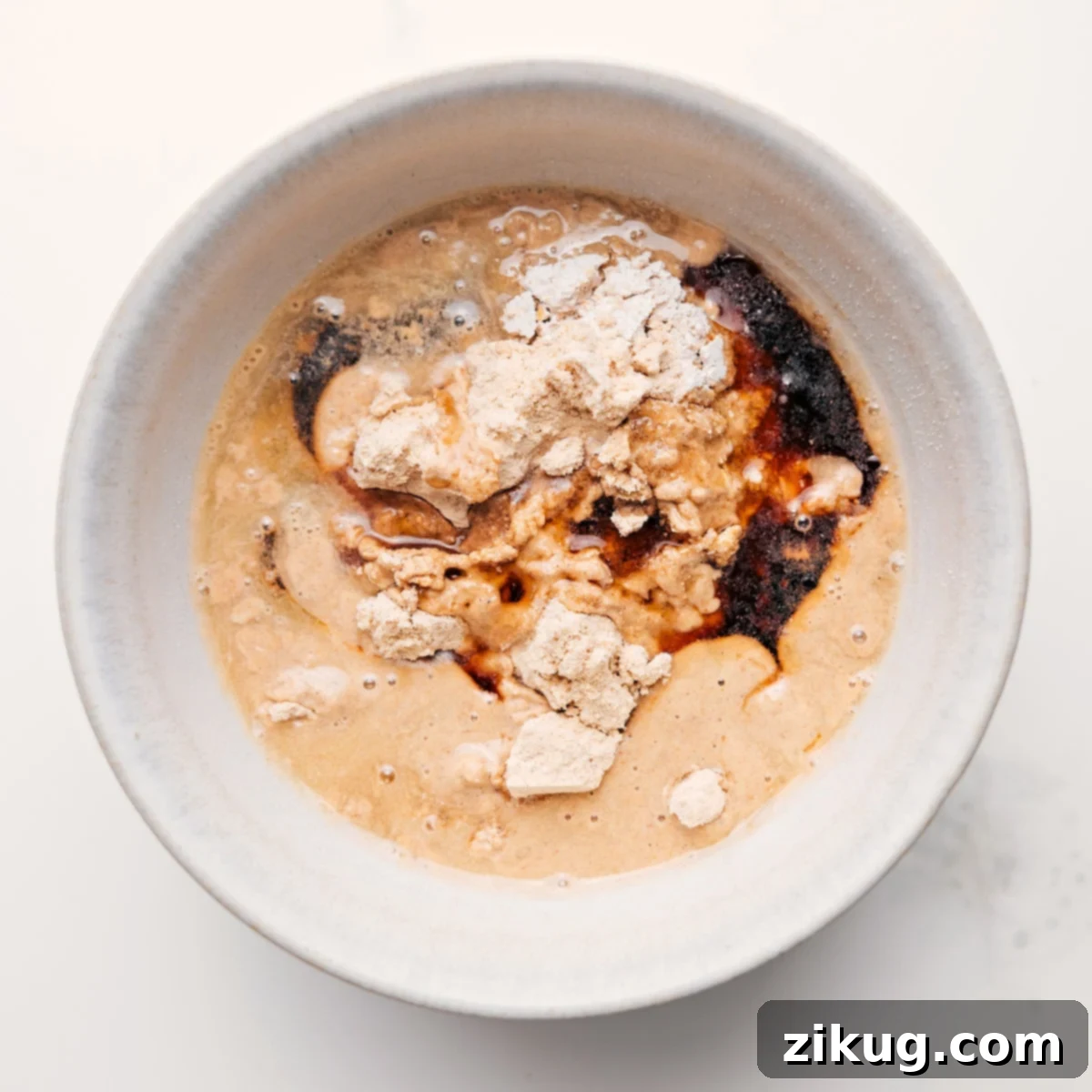 How To Make Protein Cookie Dough Perfectly Freshly made protein cookie dough with chocolate chips in a mixing bowl.