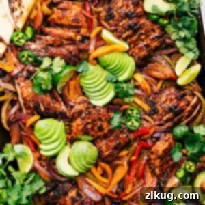 A close-up shot of juicy Sheet Pan Chicken Fajitas, showcasing tender chicken strips, colorful roasted bell peppers, and caramelized onions, ready to be served fresh.