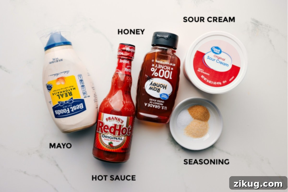 How To Make The Best Hot Honey Chicken Salad Dressing The hot honey chicken salad dressing ingredients prepped including the mayo, hot sauce, honey, sour cream, and seasoning, ready to be whisked.