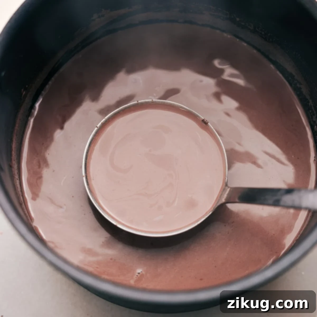 Ready-to-serve, comforting Mexican Hot Chocolate Warm, inviting Mexican Hot Chocolate prepared for pouring into a cup, promising a cozy, flavorful experience.