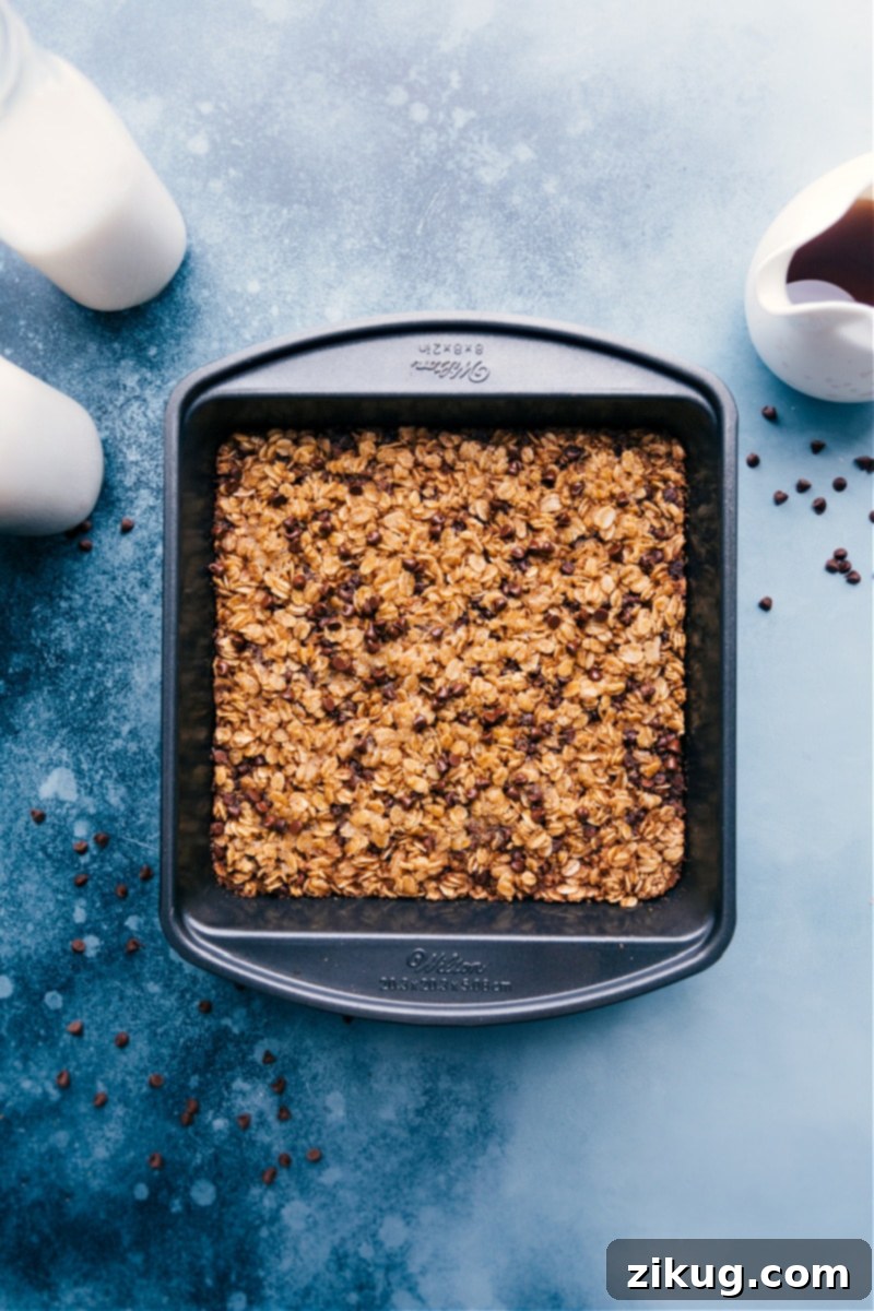 Chocolate Chip Baked Oatmeal! Recipe via ChelseasMessyApron #breakfast #quick #easy #simple #dessert #oats #brunch #chocolatechip #baked #oatmeal Chocolate Chip Baked Oatmeal cut into squares