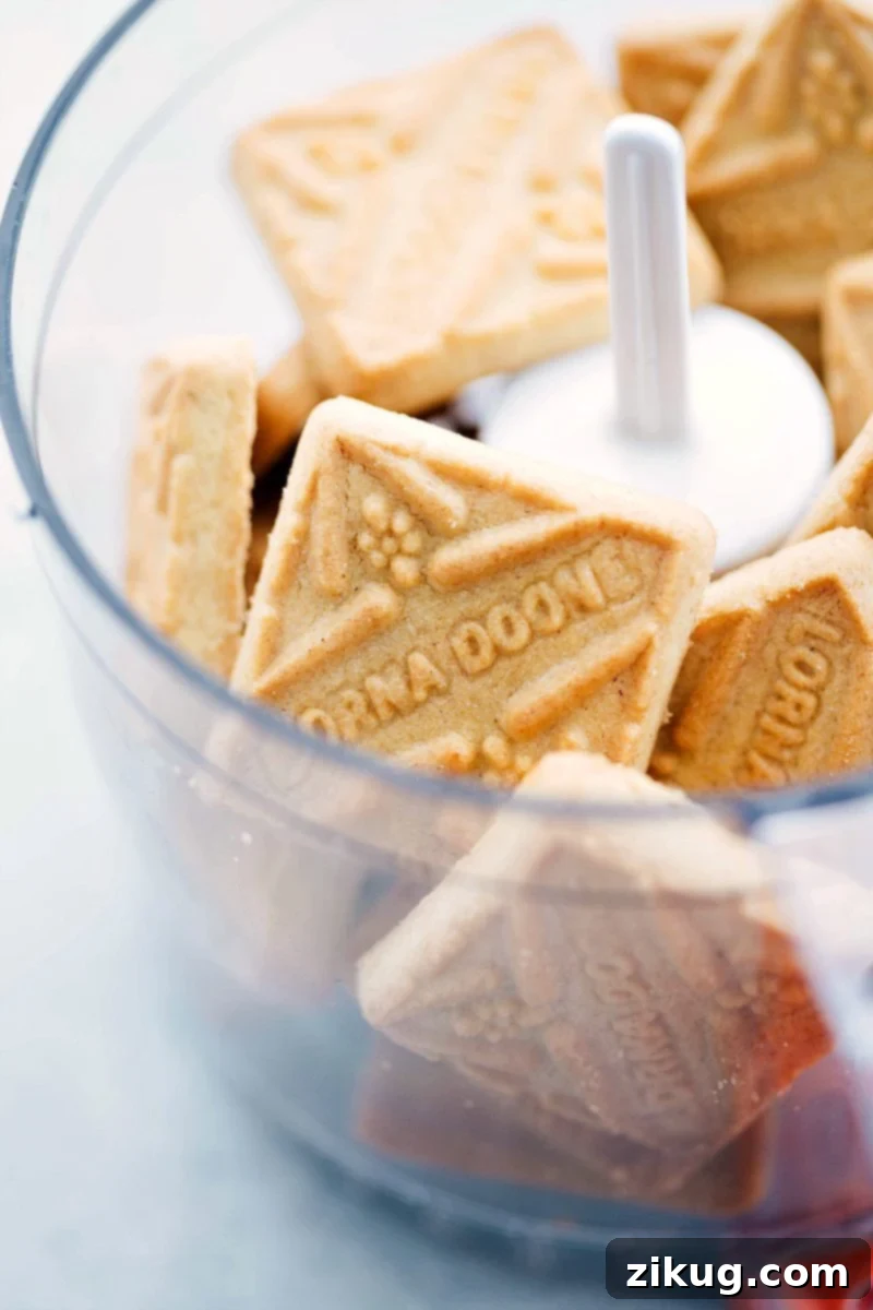 Crushing shortbread cookies for the cheesecake crust Shortbread cookies being crushed in a food processor for the crust.