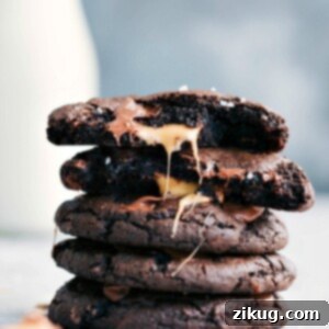 Finished Chocolate Caramel Cookies stacked, with one broken to show the melted Rolo caramel inside.