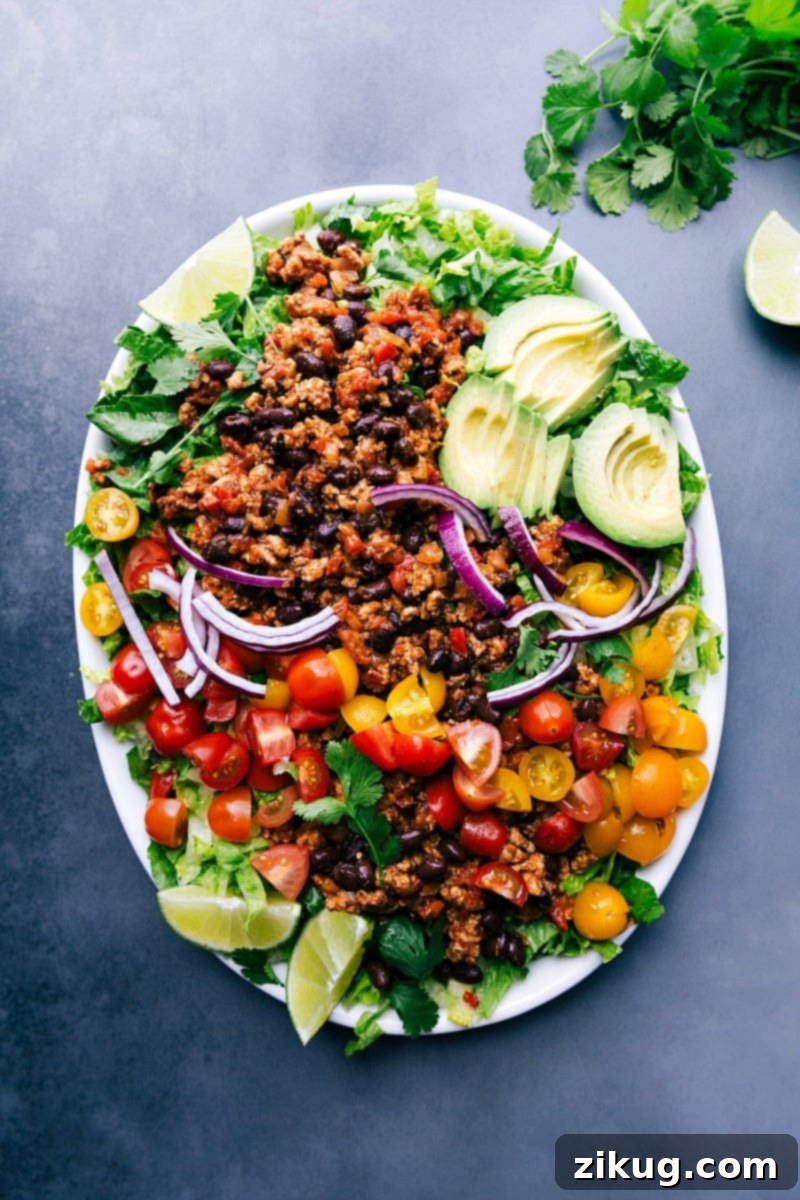 Generously Topped Ground Turkey Taco Salad, Ready to Enjoy Ground turkey taco salad complete with a variety of fresh ingredients on top, ready for serving.