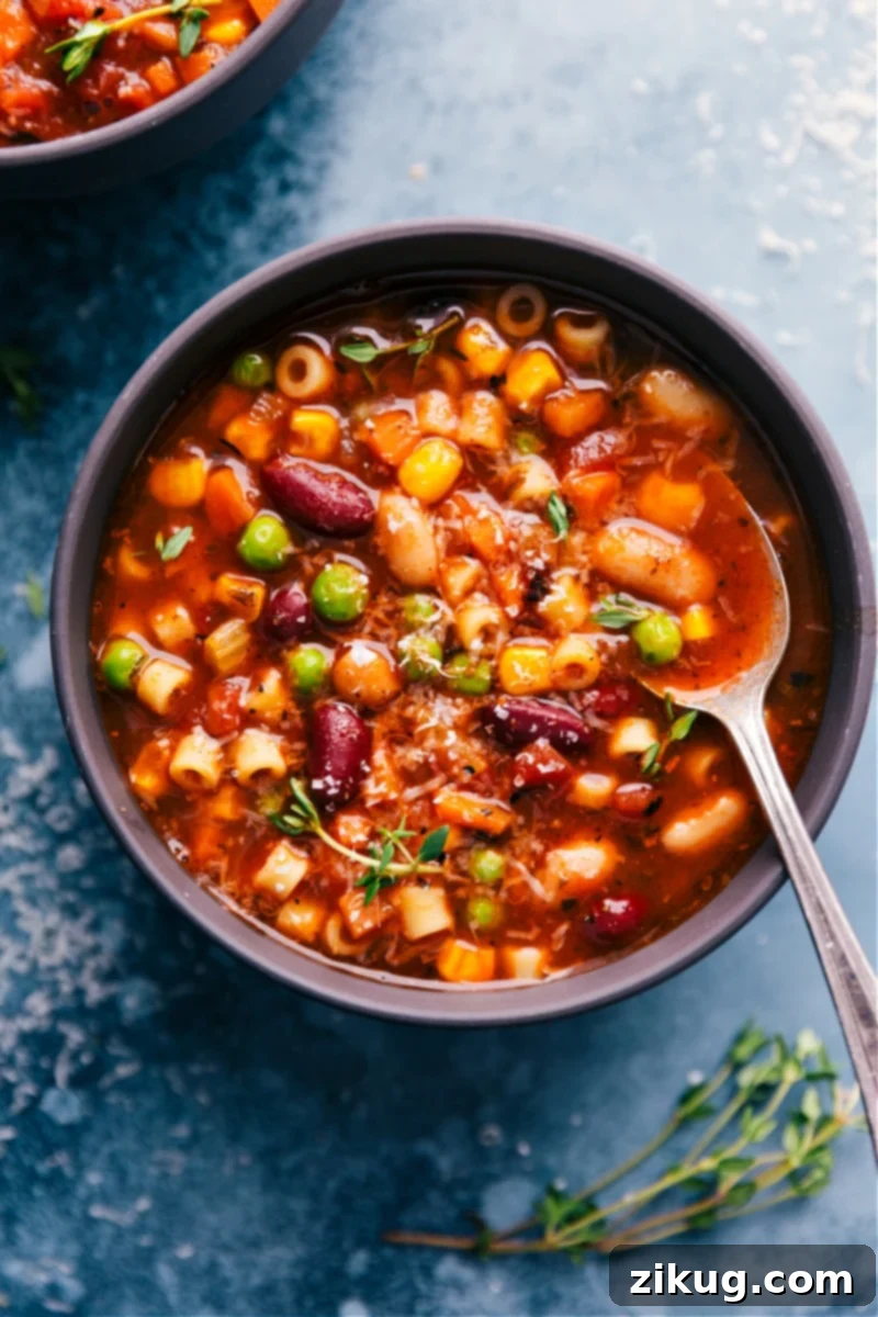 Homemade Olive Garden Minestrone Soup: The Best Copycat Recipe A steaming bowl of homemade Olive Garden Minestrone Soup, garnished with fresh herbs, ready to be enjoyed.