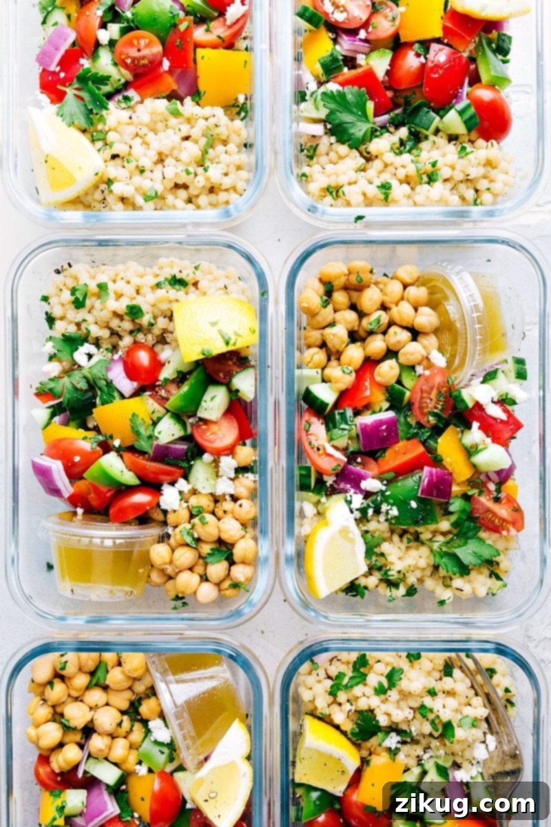 How To Make Greek Couscous Bowls Six meal prep containers filled with Greek couscous salad components, ready for the week