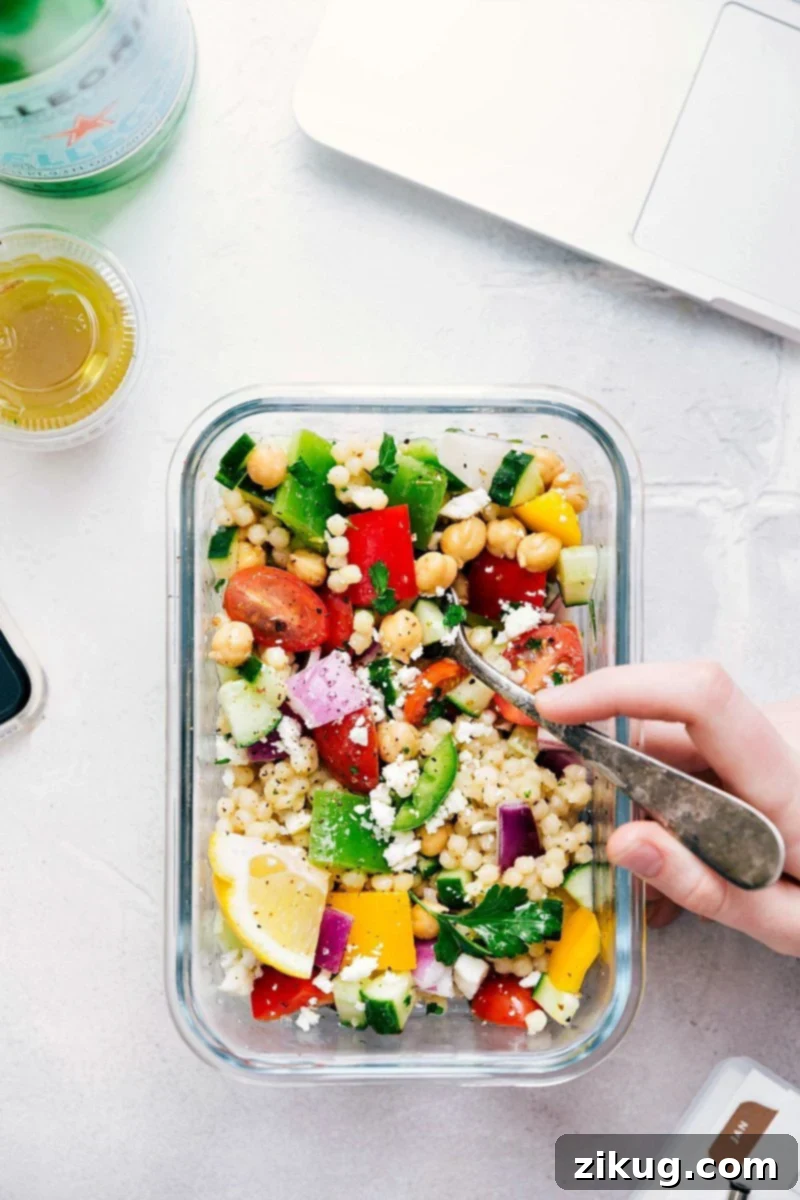 The Best Greek Couscous Salad Recipe A single serving of Greek couscous salad in a meal prep container, perfectly portioned