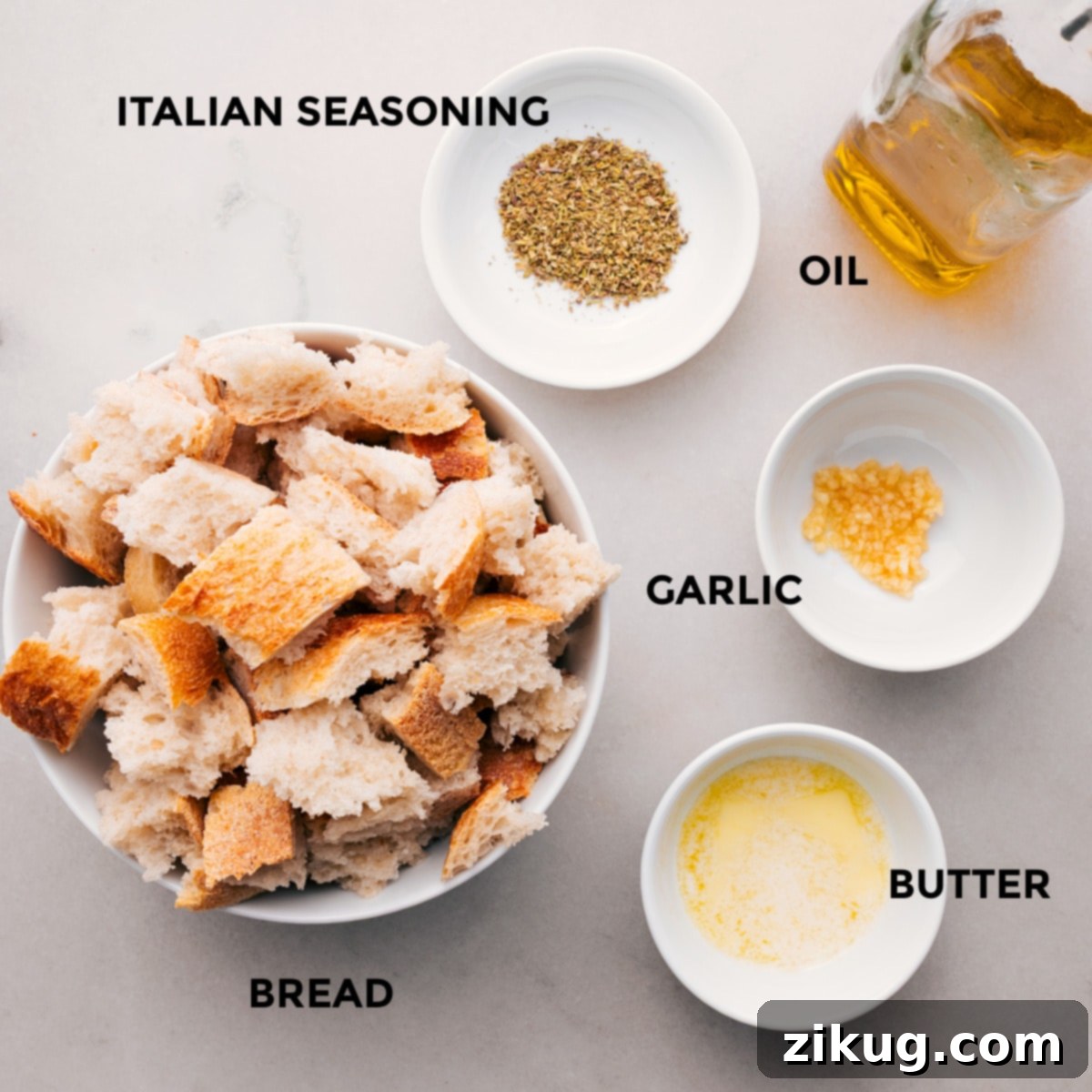 How To Make Crispy Panzanella Croutons Torn sourdough bread cubes are seasoned with Italian herbs, garlic, olive oil, and melted butter, then spread on a baking sheet, ready for roasting to create crispy croutons for Panzanella.