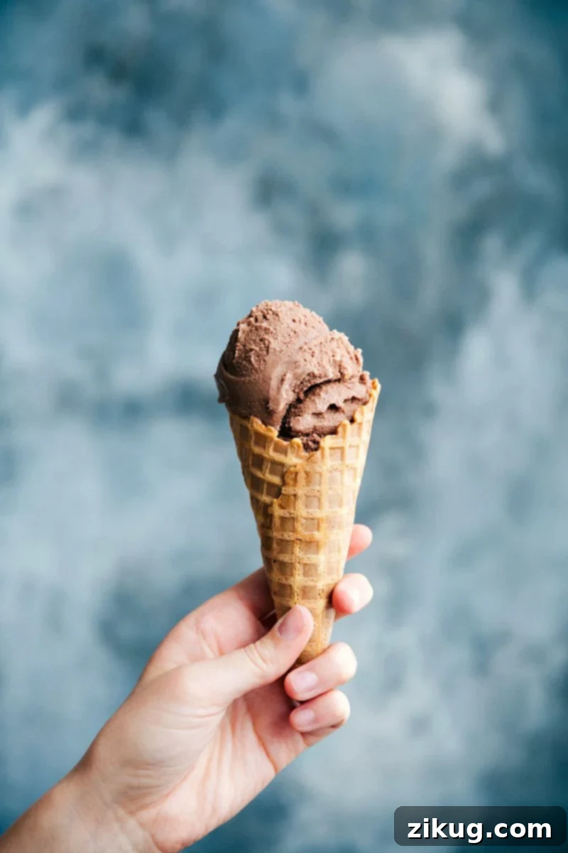 Decadent Chocolate Gelato in a Waffle Cone A waffle cone filled with rich, creamy chocolate gelato, promising a decadent dessert experience.