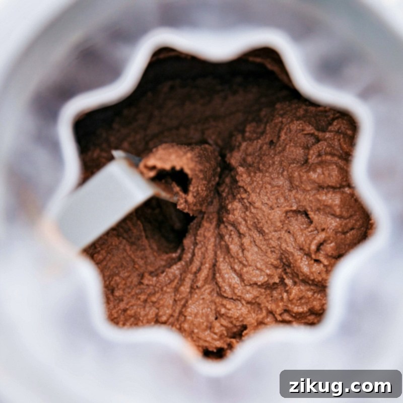 Churning Chocolate Gelato to Perfection Rich chocolate gelato churning in an ice cream maker, showcasing the creamy, smooth texture being developed.