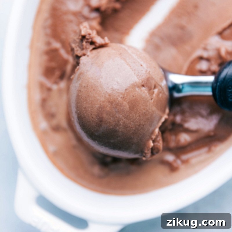 Scooping Delicious Homemade Gelato A scoop of refreshing and flavorful gelato being lifted with an ice cream scoop, ready to be enjoyed.