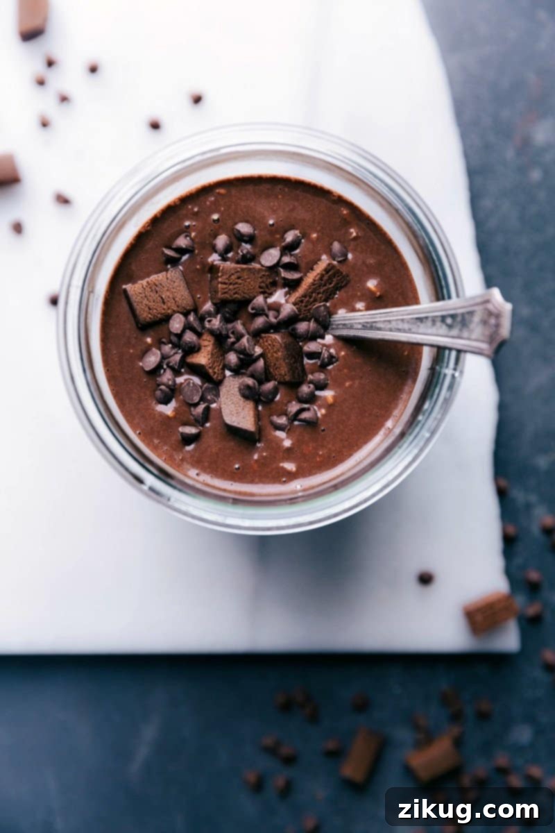Brownie Batter Overnight Oats with Chocolate Chips and Brownie Bites - Sweet Breakfast Delight Brownie batter overnight oats, topped with chocolate chips and brownie bites for a sweet and delicious breakfast treat.