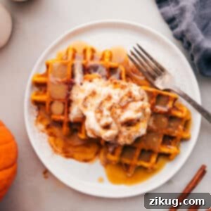 Close-up of a stack of fluffy pumpkin waffles.