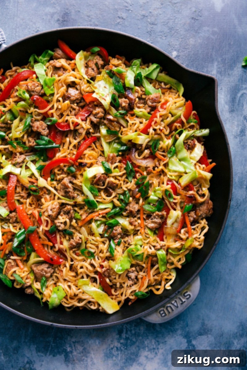 Completed Egg Roll Noodles in a large skillet, beautifully garnished with fresh green onions.