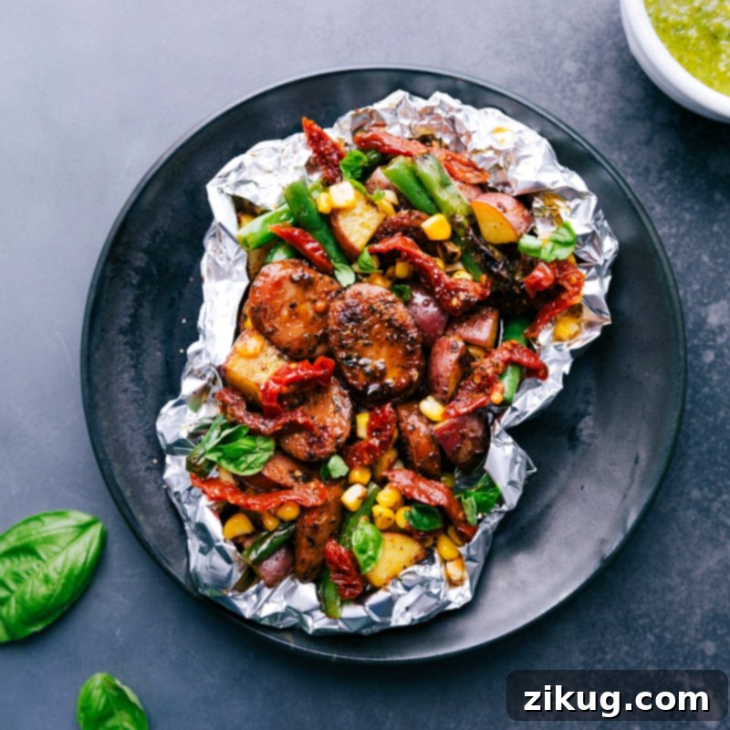 Freshly Grilled Pesto and Sausage, Steaming and Ready to Enjoy A freshly grilled pesto and sausage foil pack, steaming hot and just off the grill, ready to be served and enjoyed.