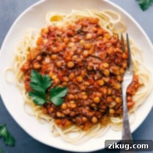 Hearty Lentil Bolognese 3 Lentil bolognese served over spaghetti, presenting a savory and mouth-watering meal.