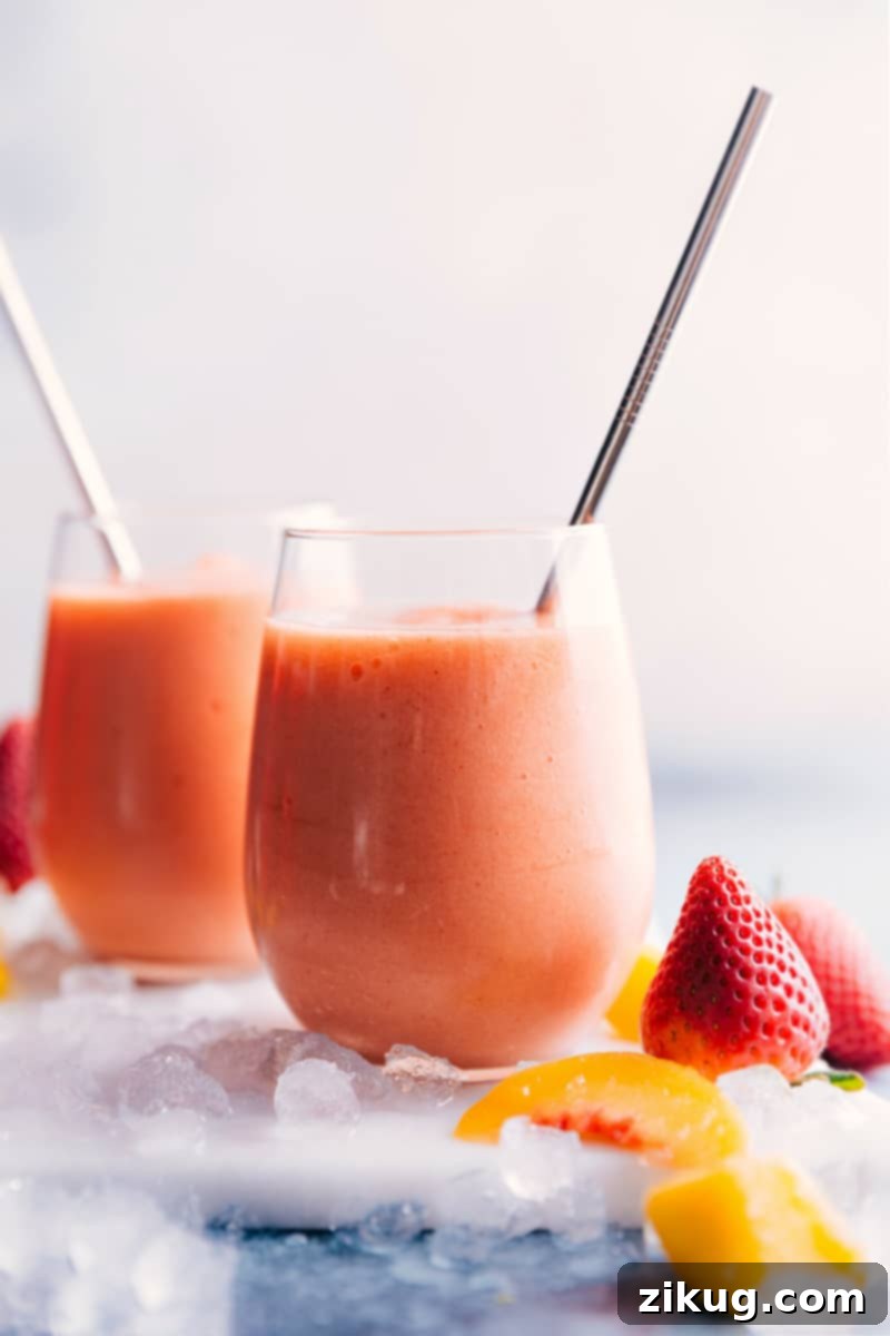 Sip on this delightful Jamba Juice Caribbean Passion Smoothie copycat, blended with passion fruit juice, frozen fruit, ice, and orange sherbet for a refreshing treat. Close-up of two Caribbean Passion Smoothies, showing off their beautiful color and texture.