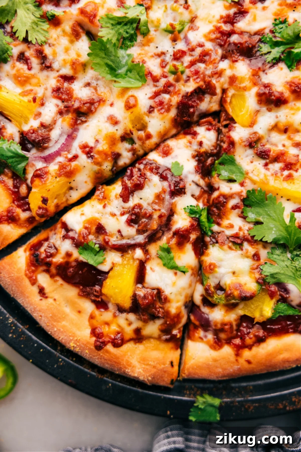 Easy And Delicious BBQ Chicken Pizza Recipe Freshly baked BBQ Chicken Pizza topped with cilantro, sliced and ready to be served.