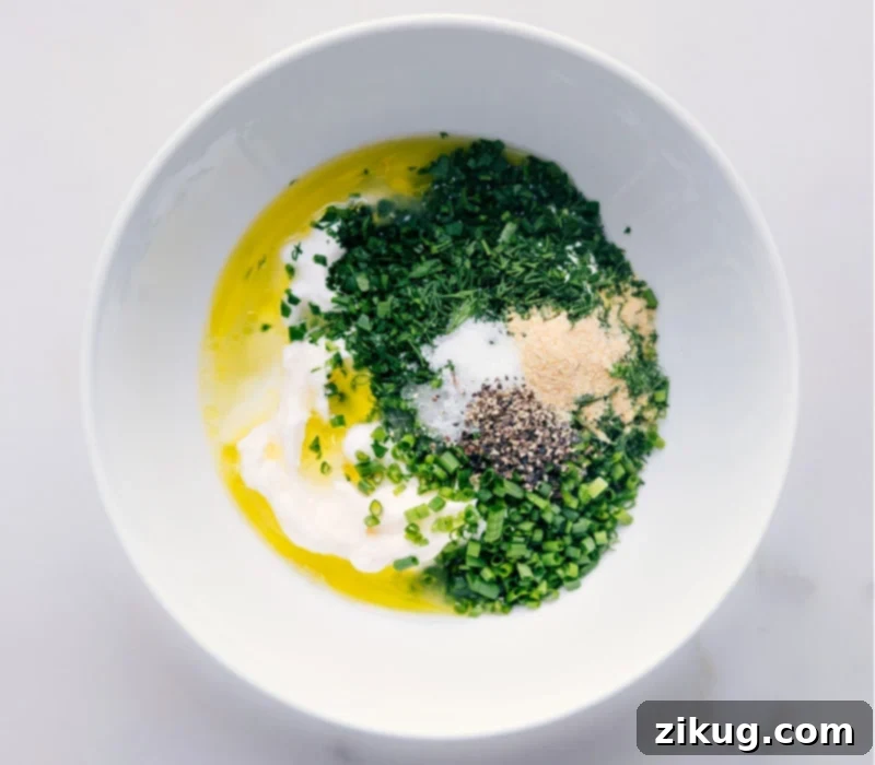 How To Make Buttermilk Ranch Dressing Recipe The olive oil being added into the bowl with all the other ingredients for this buttermilk ranch dressing recipe.