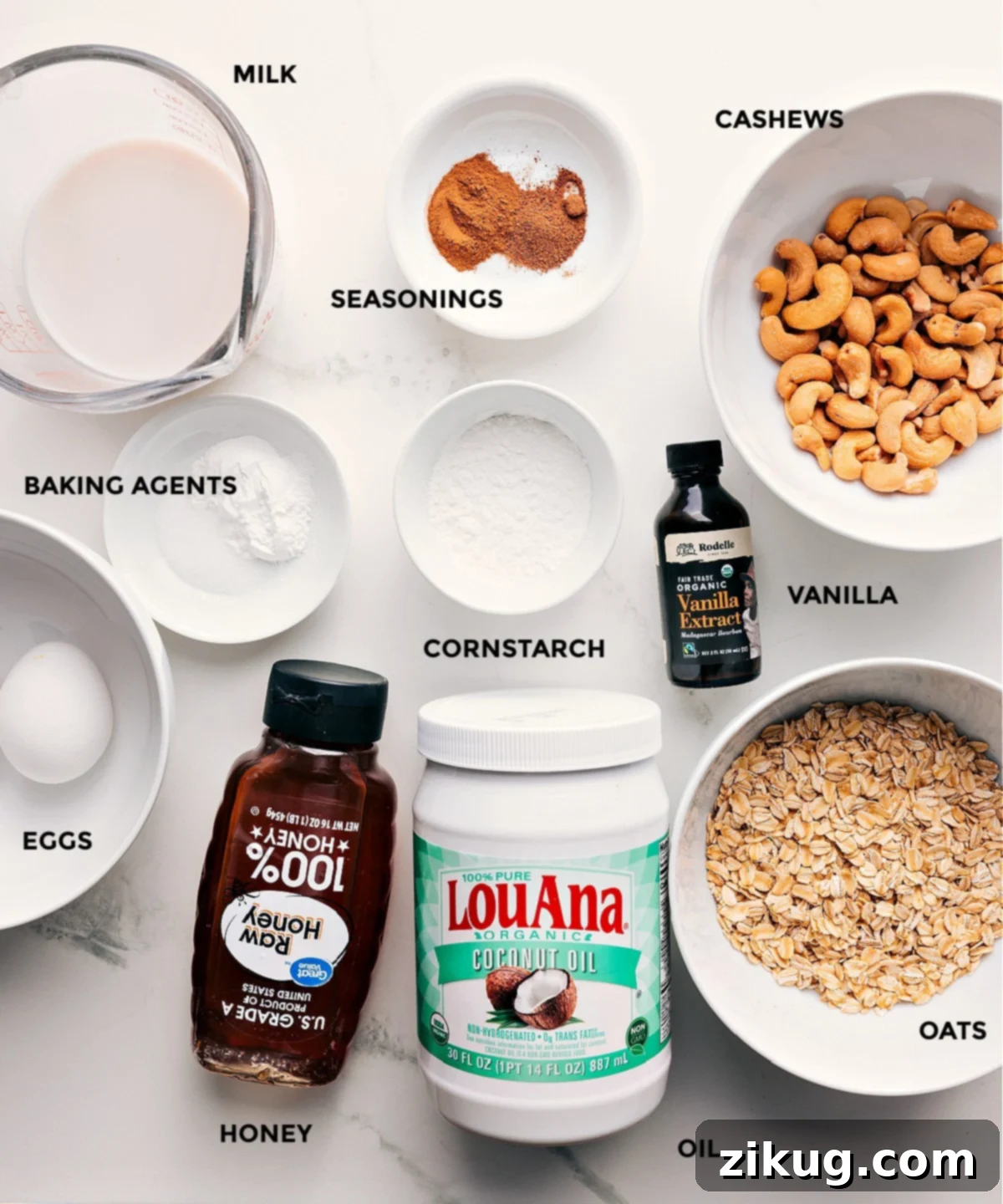 Ingredients In Healthy Pancake Recipe All the ingredients in this recipe prepped out for easy assembly including milk, seasonings, cashews, vanilla, cornstarch, baking agents, oats, coconut oil, honey, and eggs.