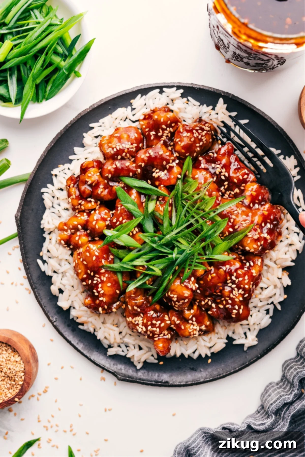 Korean Fried Chicken: A Flavor Explosion 2 Korean Chicken Recipe served on a bed of rice, garnished with fresh green onions and sesame seeds.