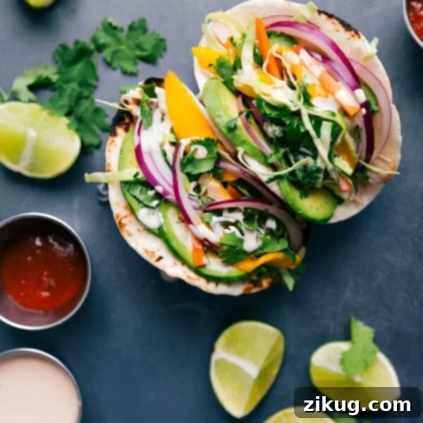 Asian chicken tacos stuffed with chicken, vegetables, and a complementary sauce, ready to be enjoyed.
