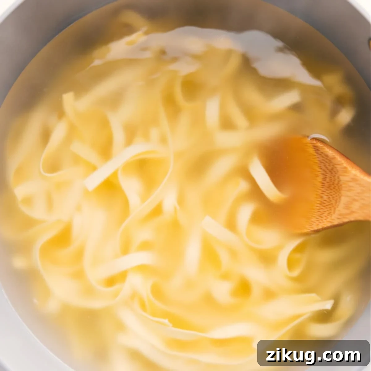 Olive Garden's Fettuccine Alfredo: A Homemade Twist 4 Fettuccine noodles boiling in a pot for Olive Garden Fettuccine Alfredo recipe.
