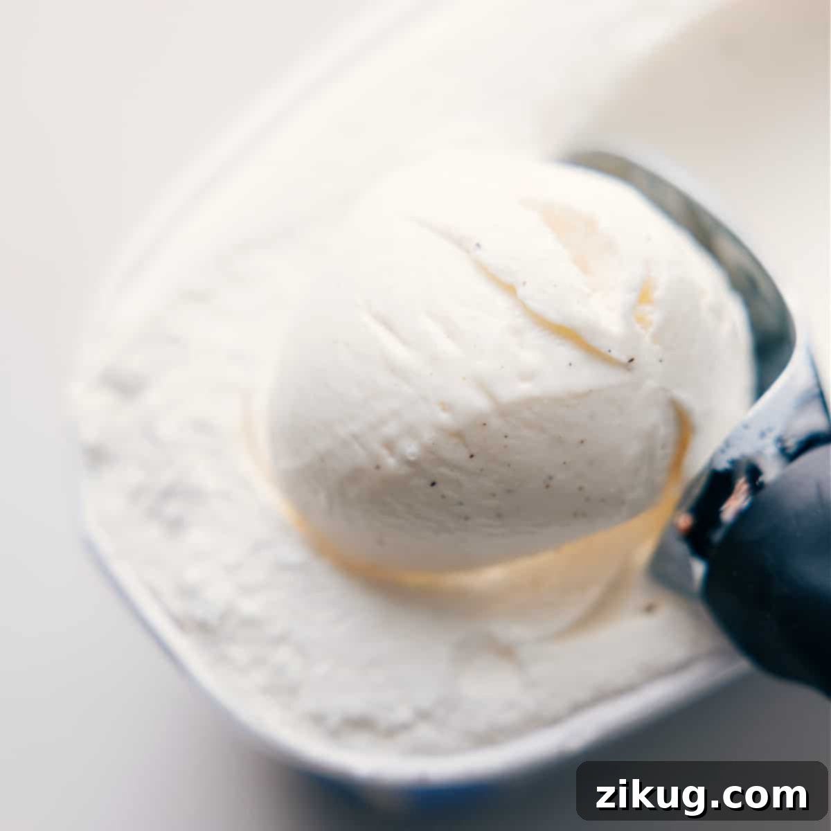 Scooping vanilla bean ice cream into a blender for a Shamrock Shake.