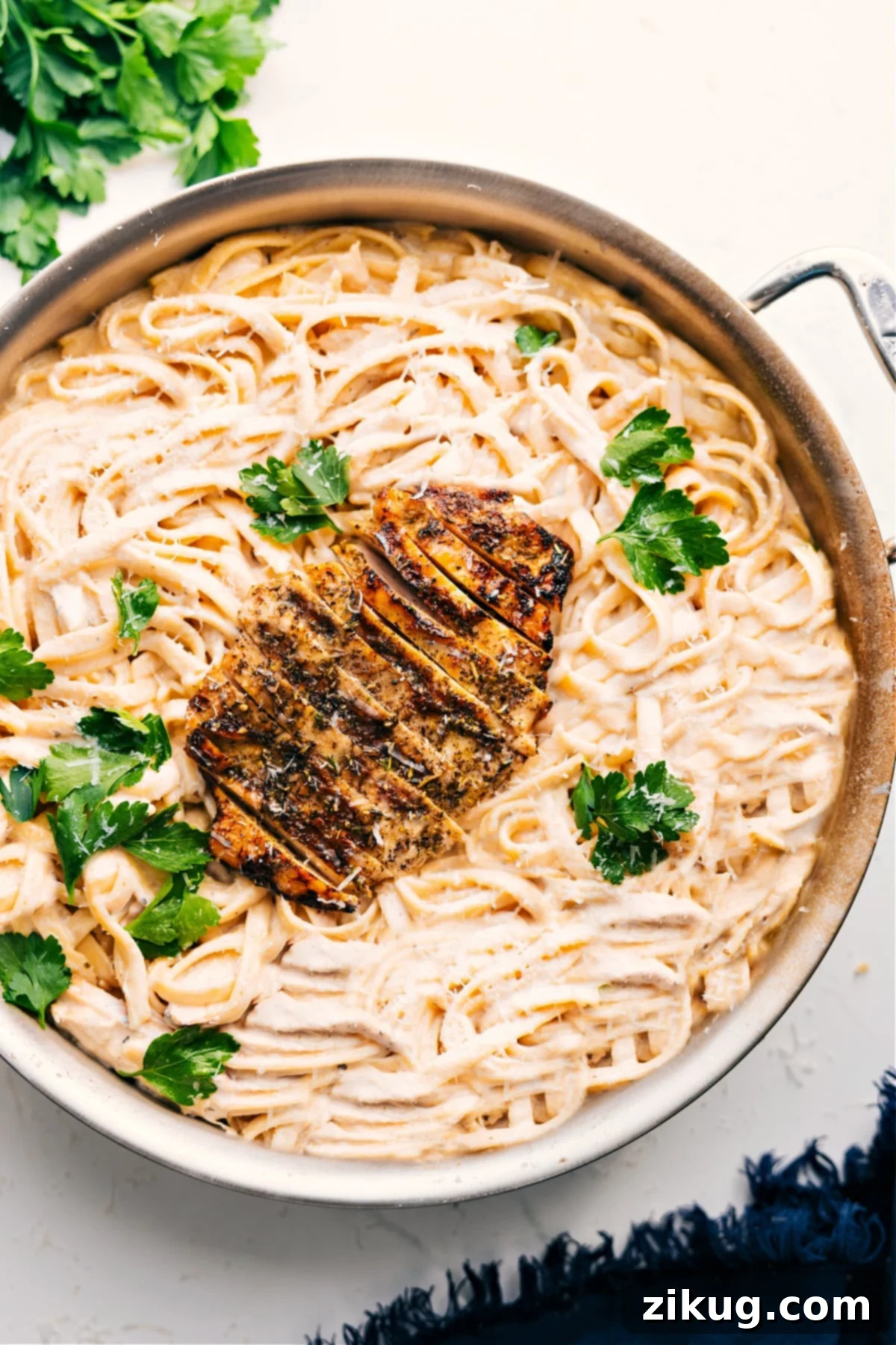 Deliciously Creamy Chicken Alfredo 2 Chicken Alfredo Recipe - Cooked chicken on top of creamy fettuccine
