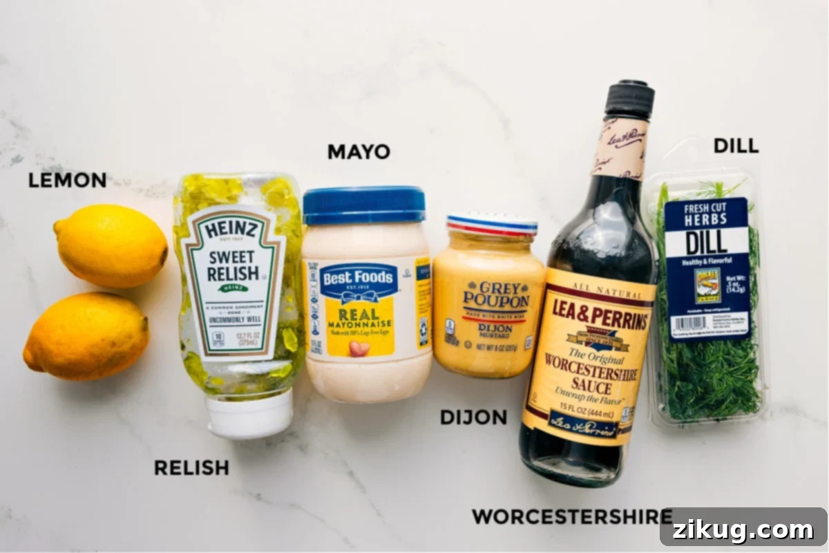 The freshest ingredients are key to crafting the most delicious homemade Tartar Sauce. A collection of fresh, high-quality ingredients for tartar sauce, including bright yellow lemons, fresh green dill sprigs, a jar of sweet pickle relish, and a bowl of creamy mayonnaise, arranged appealingly.