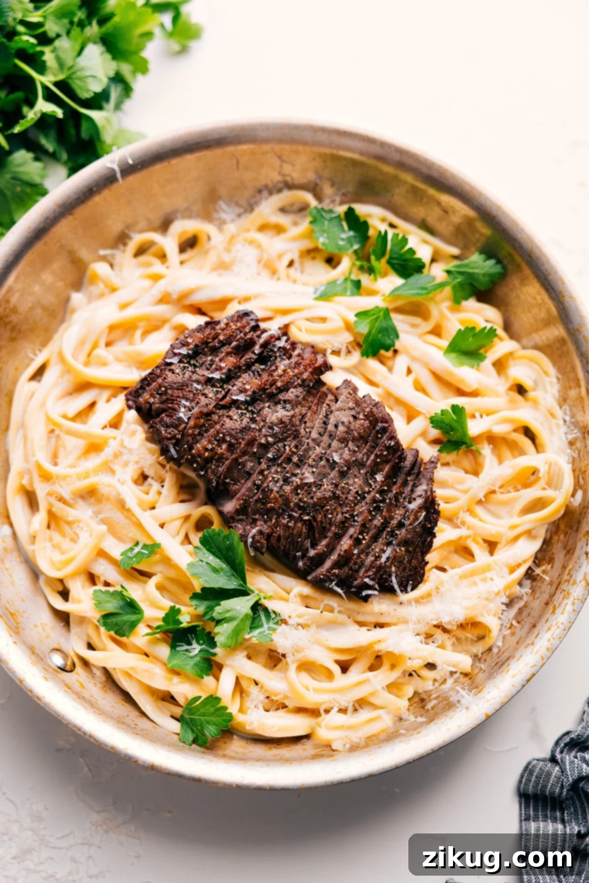 Steak Alfredo Recipe That Tastes Fancy But Couldn't Be Easier To Make Steak Alfredo Recipe in the pot topped with fresh parsley, ready to be served.