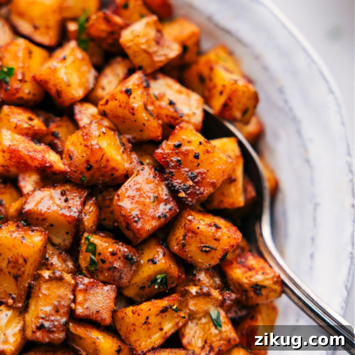 Perfect Brunch Breakfast Potatoes Serving Close-up image of the crispy breakfast potatoes, with a spoon scooping a portion out.